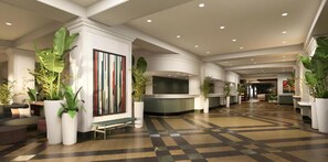 Eine Hotelhalle mit Empfangstresen, einer Sitzecke und Zimmerpflanzen.