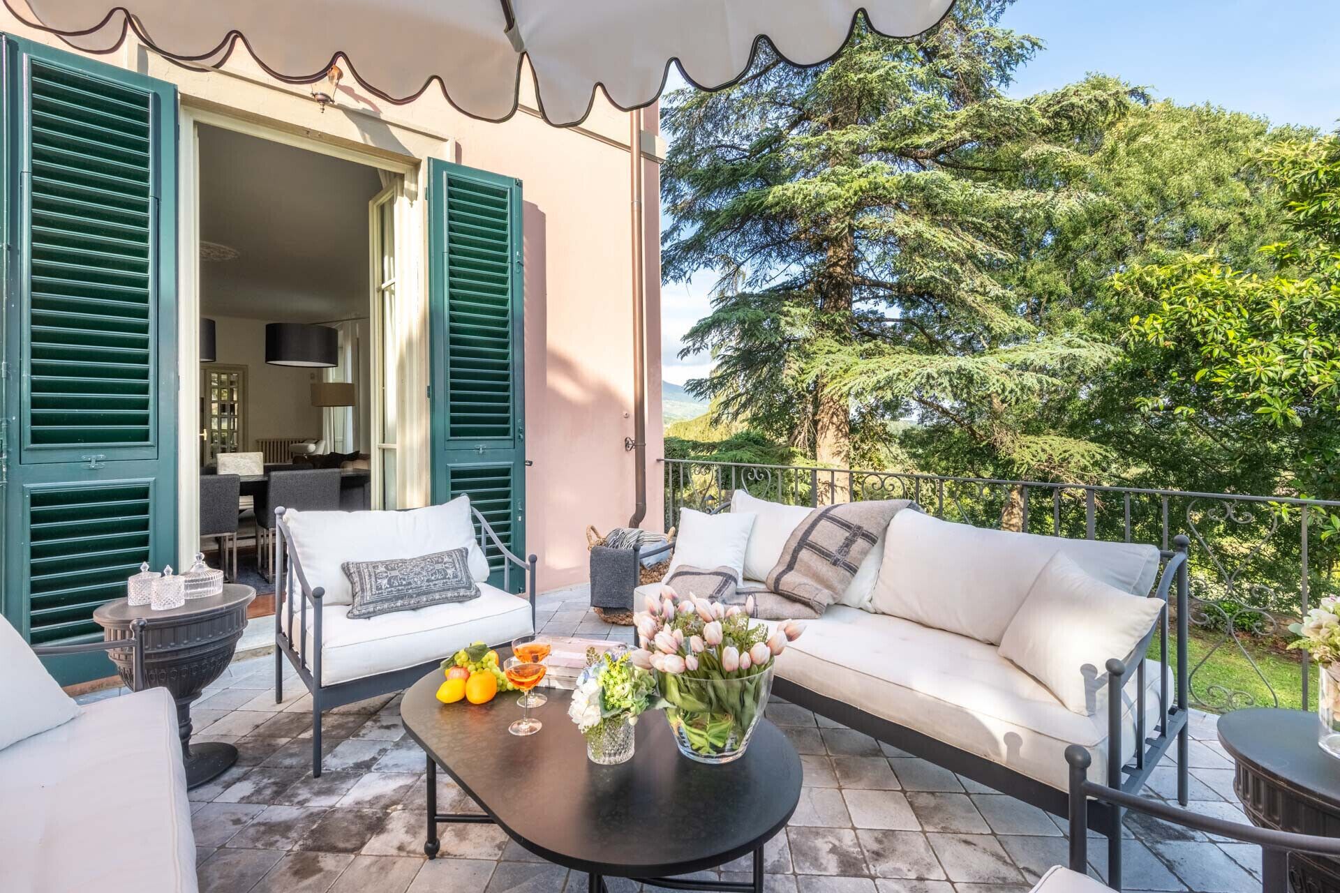 An outdoor seating area with a table, chairs, and a sofa.