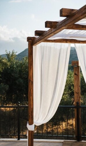 A wooden pergola structure with white drapes. - Villa Elia Provarma by Your Villa (Stilos)