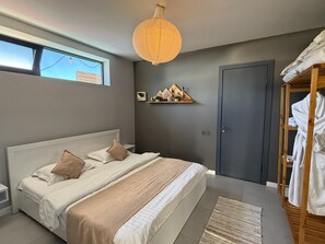 A modern bedroom with a large bed, a bedside table, a wardrobe, a hanging light fixture, and a window. - Balandda Chimgan (Chimgan)