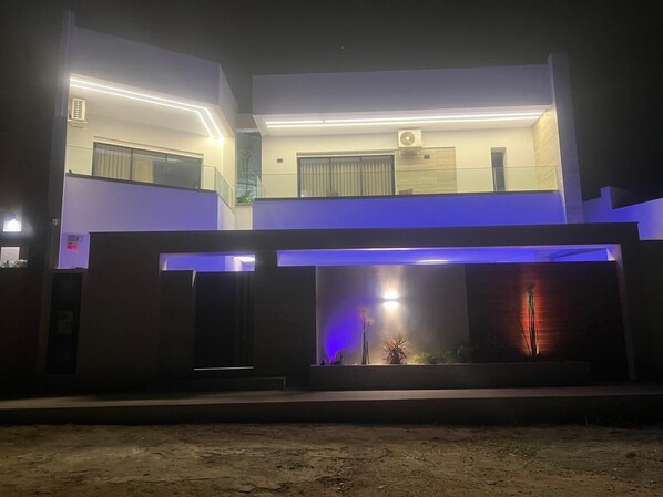 A two-story building with a modern design, featuring a balcony on the upper floor and a flat roof. - VILLA ASIA (MAAMOURA)