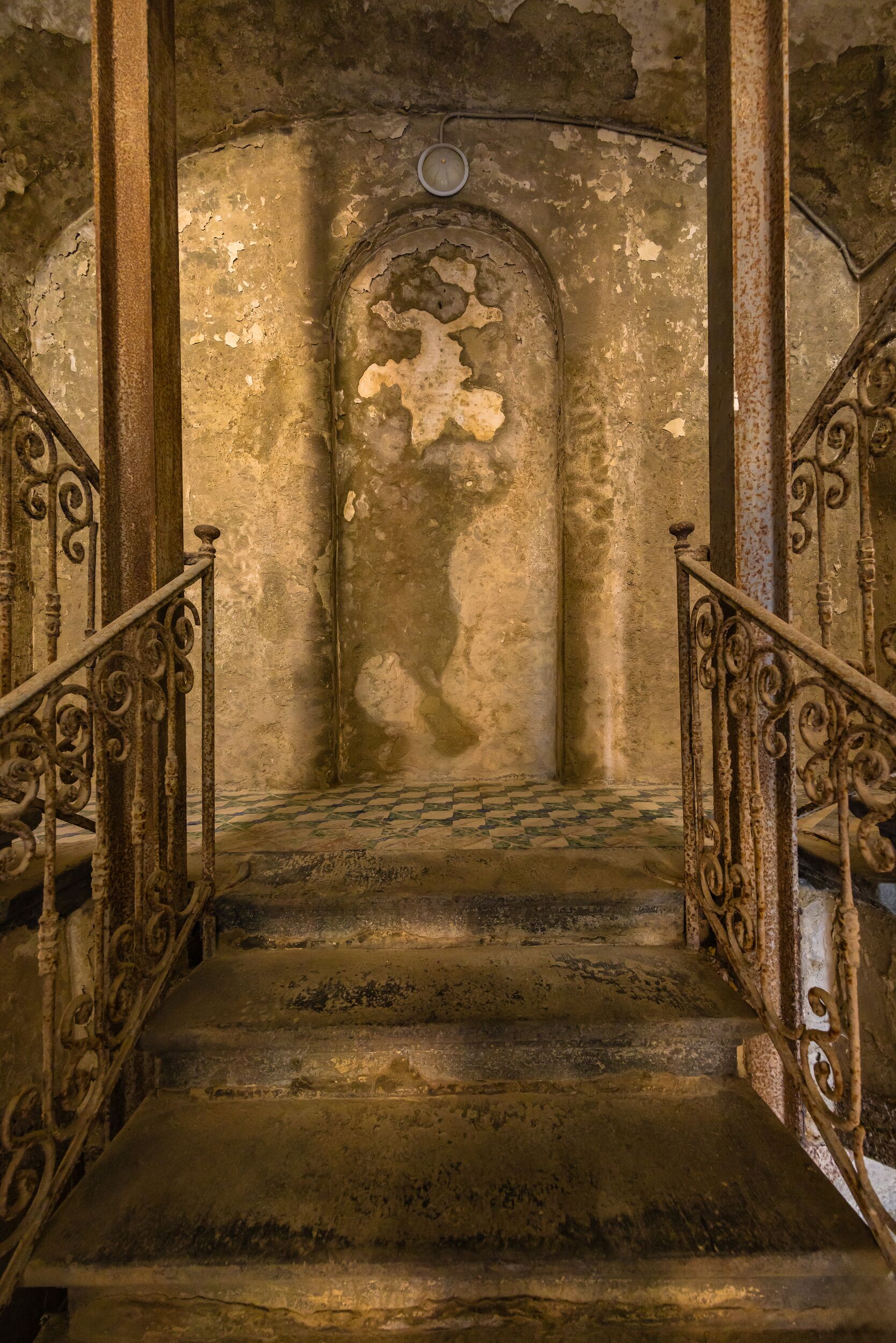 A staircase with ornate metal railings leading to a higher level.