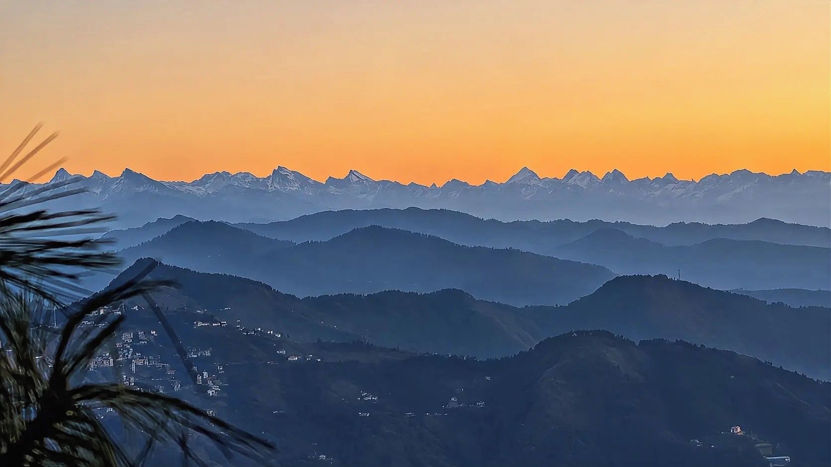 A mountainous landscape with a clear sky at dusk.