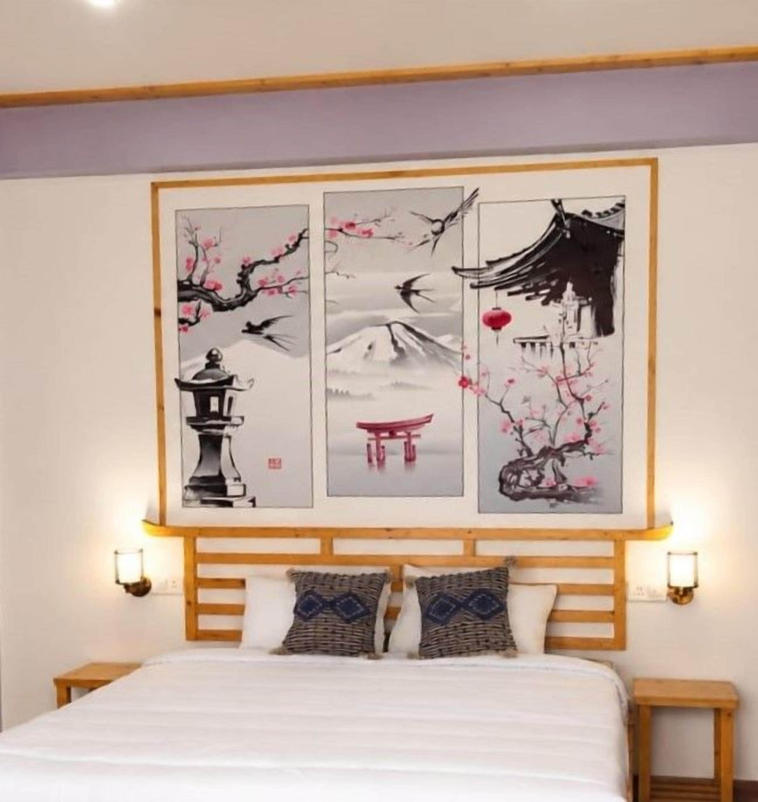 A bedroom with a bed, wooden headboard, and a wall-mounted artwork depicting cherry blossoms and traditional architecture.