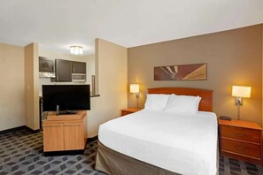 A hotel room with a bed, a television, a desk with a computer, and a microwave. - Your Home Base Near Philly + Free Parking. Kitchen (Mount Laurel)