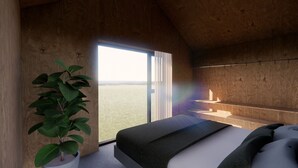 A bedroom with a large window, a bed, and a potted plant. - Þjórsárdalur Lodges & Cabins (Skeiða- og Gnúpverjahreppur)