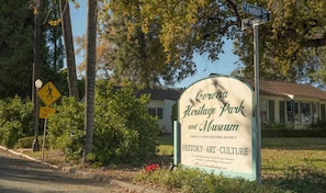 A sign for Corona Heritage Park and Museum, indicating it is the first historic district of Corona. - Near The Shops at Dos Lagos | Full Kitchen & Gym (Corona)