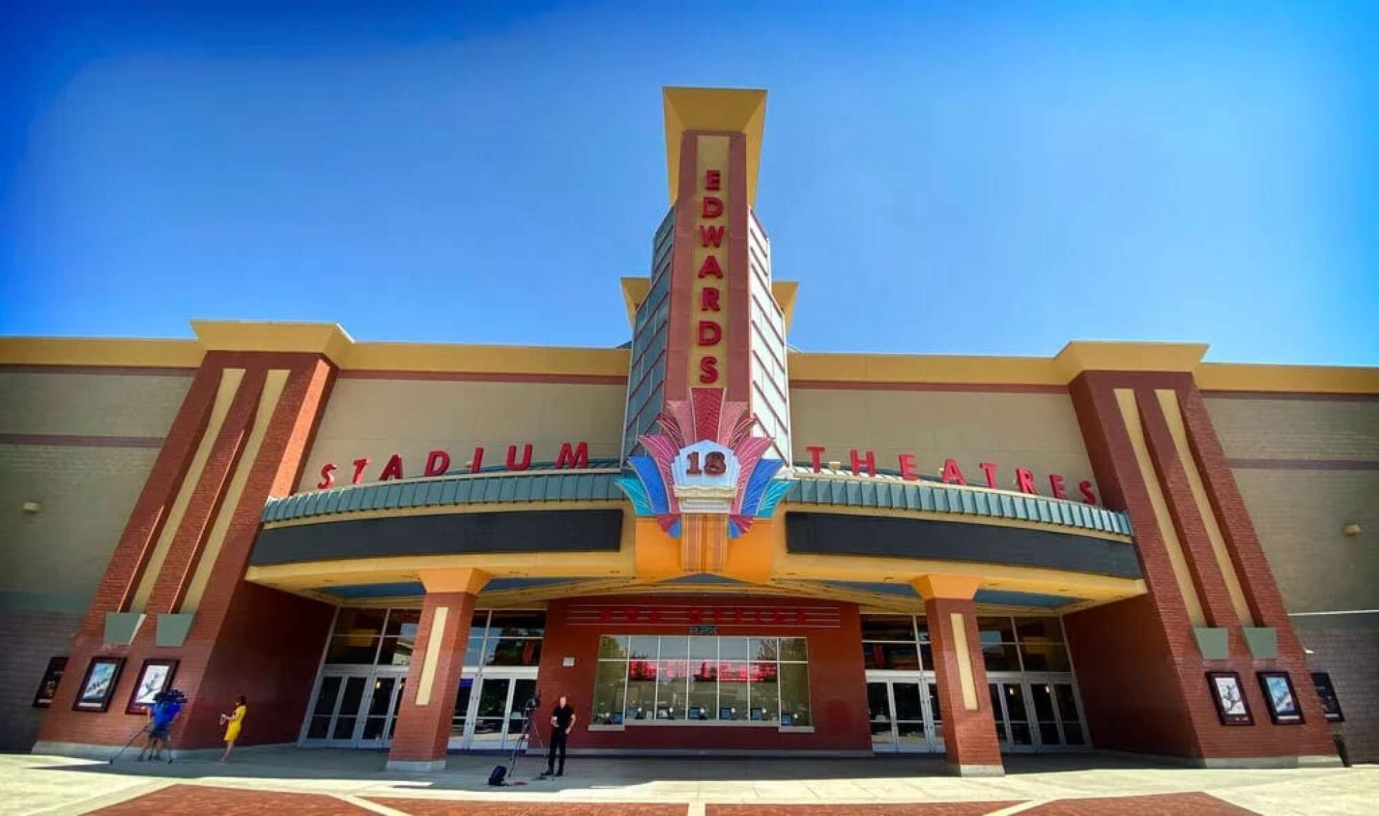 A large, modern theater with a prominent marquee reading 'EDWARDS STADIUM THEATRES'.