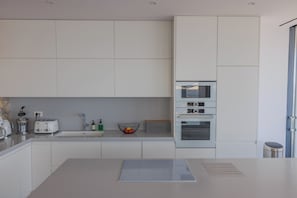 A modern kitchen with white cabinetry, a Bosch oven, and a bread box. - The Luminous Villa: private estate, 4 sea-view suites, heated pool, sleeps 8 (Volimes)