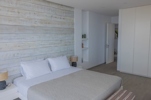 A bedroom with a bed, bedside tables, a wardrobe, and a hallway. - The Luminous Villa: private estate, 4 sea-view suites, heated pool, sleeps 8 (Volimes)