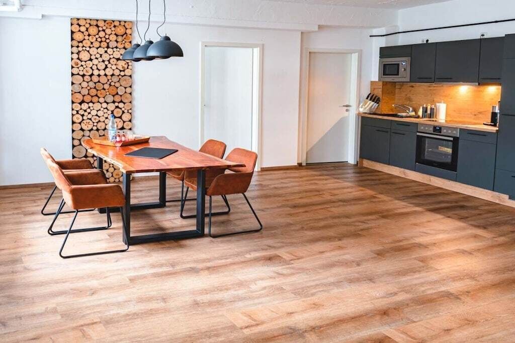 A modern kitchen with dark cabinets, a microwave, and a stove.