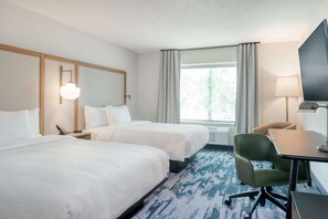 A hotel room with two beds, a desk, a chair, a television, and a window with curtains. - Near Weissinger Hills Golf Course + Free Breakfast (Shelbyville)