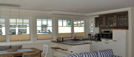 A compact living space with a kitchenette, dining area, and a sofa.