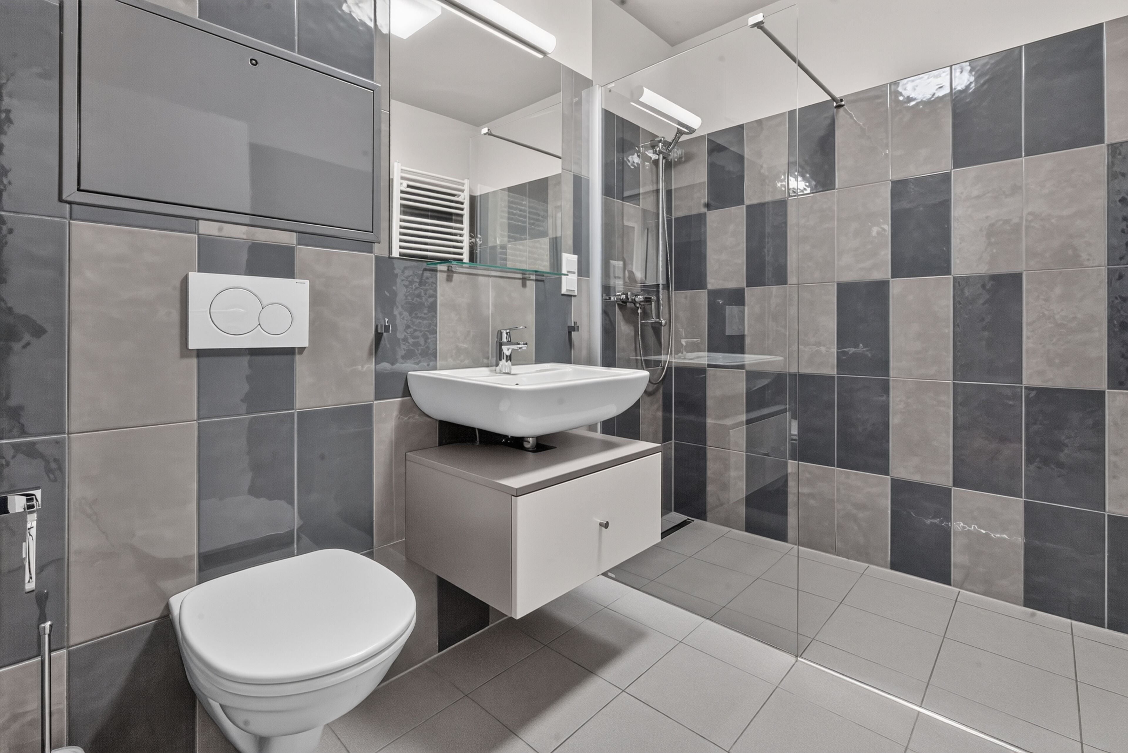 Un baño moderno con inodoro, lavabo y ducha.