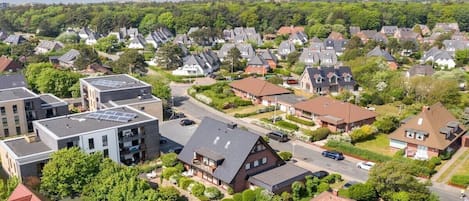 Un barrio residencial con casas, calles y zonas verdes.