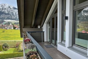 A modern building with a balcony overlooking a mountainous landscape. - Holiday apartment with 2 bedrooms (Oberstdorf)