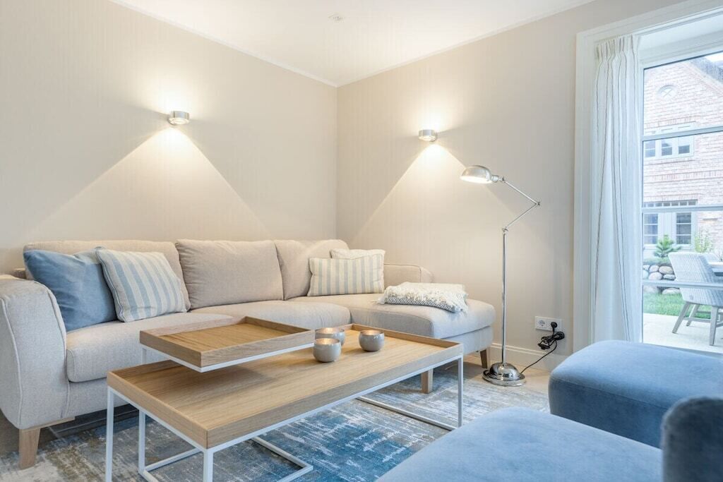 A modern living room with a sofa, coffee table, and floor lamp.