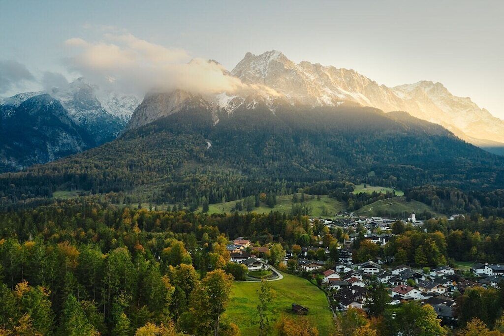 A mountainous landscape with a village nestled in the valley.