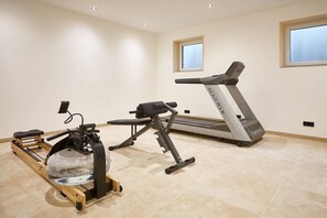 A home gym with a rowing machine, a stationary bike, and a treadmill. - WALDECK in the CHALET ZUGSPITZEREI (Grainau)