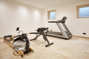 A home gym with a rowing machine, a stationary bike, and a treadmill. - SCHÖNANGER in the CHALET ZUGSPITZEREI (Grainau)