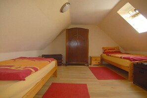 A small, cozy attic bedroom with two beds, a wardrobe, and a skylight. - Holiday home with 3 bedrooms (Dufftown \/ Glennrinnes)