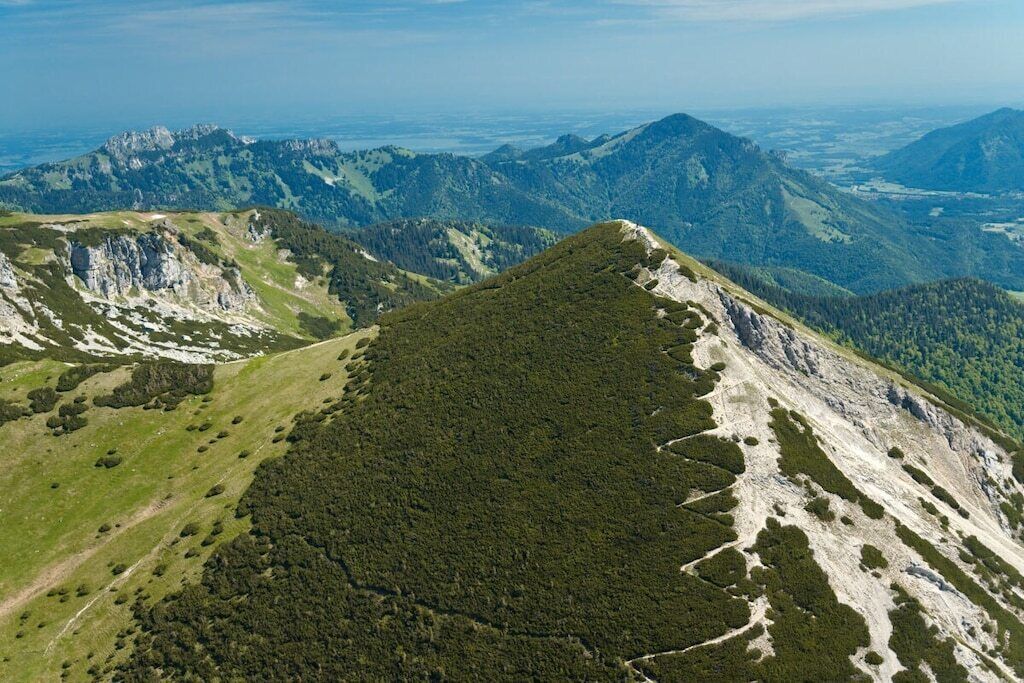 A mountainous landscape with a prominent peak and surrounding valleys.