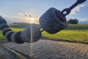 A series of spherical stone structures with a flag in the background. - Holiday apartment with 1 bedroom (Friedrichskoog)