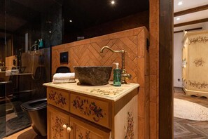 A bathroom vanity with a stone basin, a faucet, and a soap dispenser. - Gradina Snagov (Sat Snagov, Comuna Snagov)