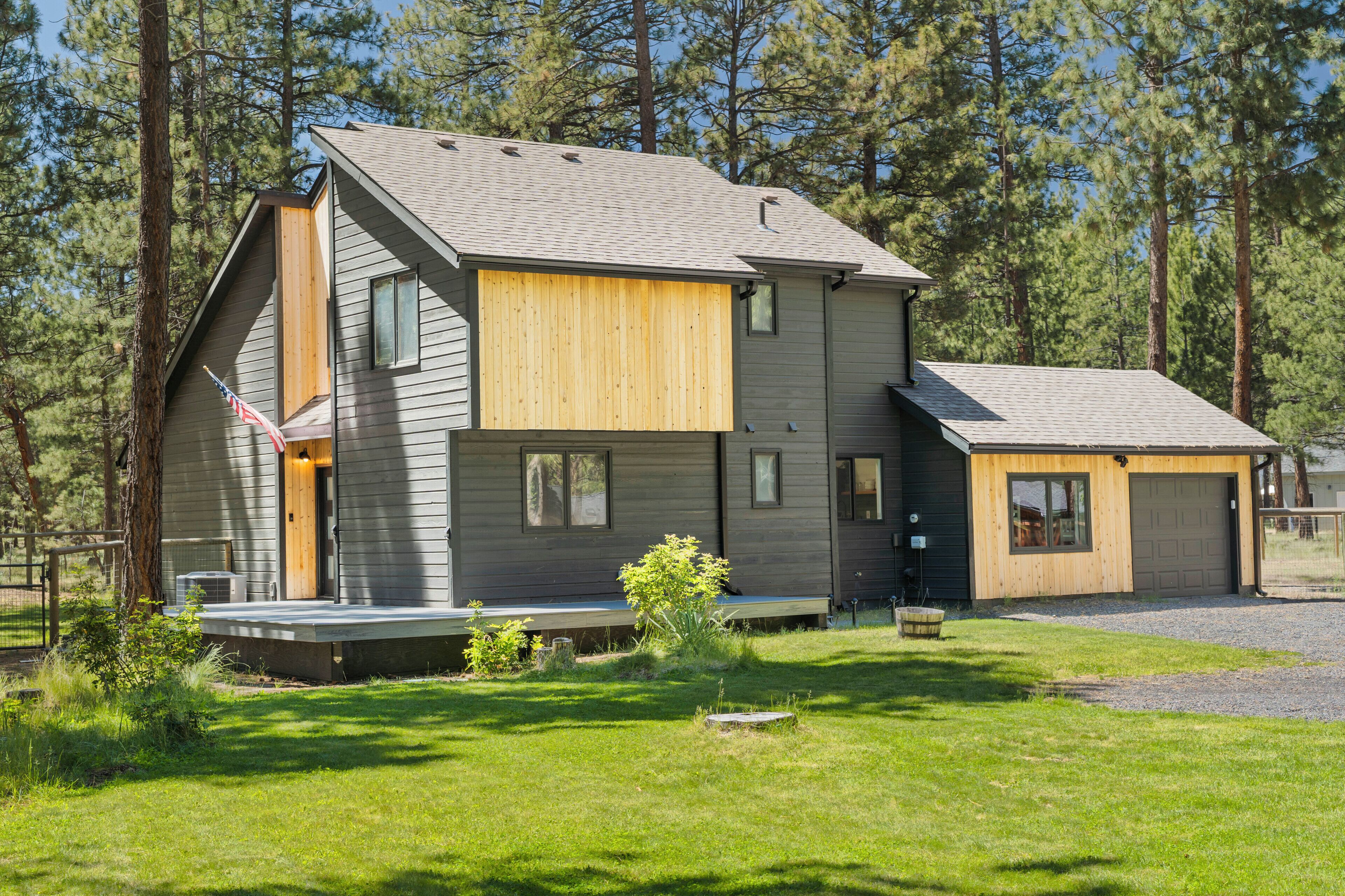 A modern two-story house with a sloped roof, a front porch, and a garage.