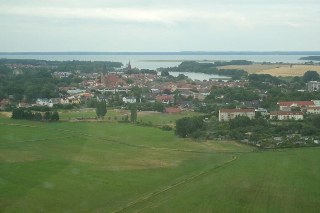 Une ville avec une église, des immeubles d’habitation et, au loin, une vaste étendue d’eau.