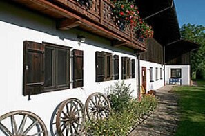 A traditional building with wooden balconies and large windows.