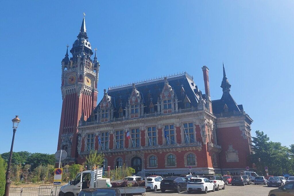 A historic building with a prominent clock tower and a large central entrance.