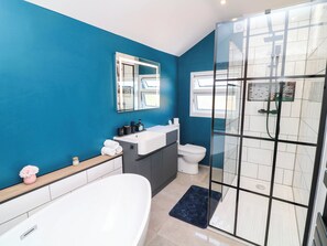 Ein modernes Badezimmer mit Badewanne, Toilette und einer Duschkabine.