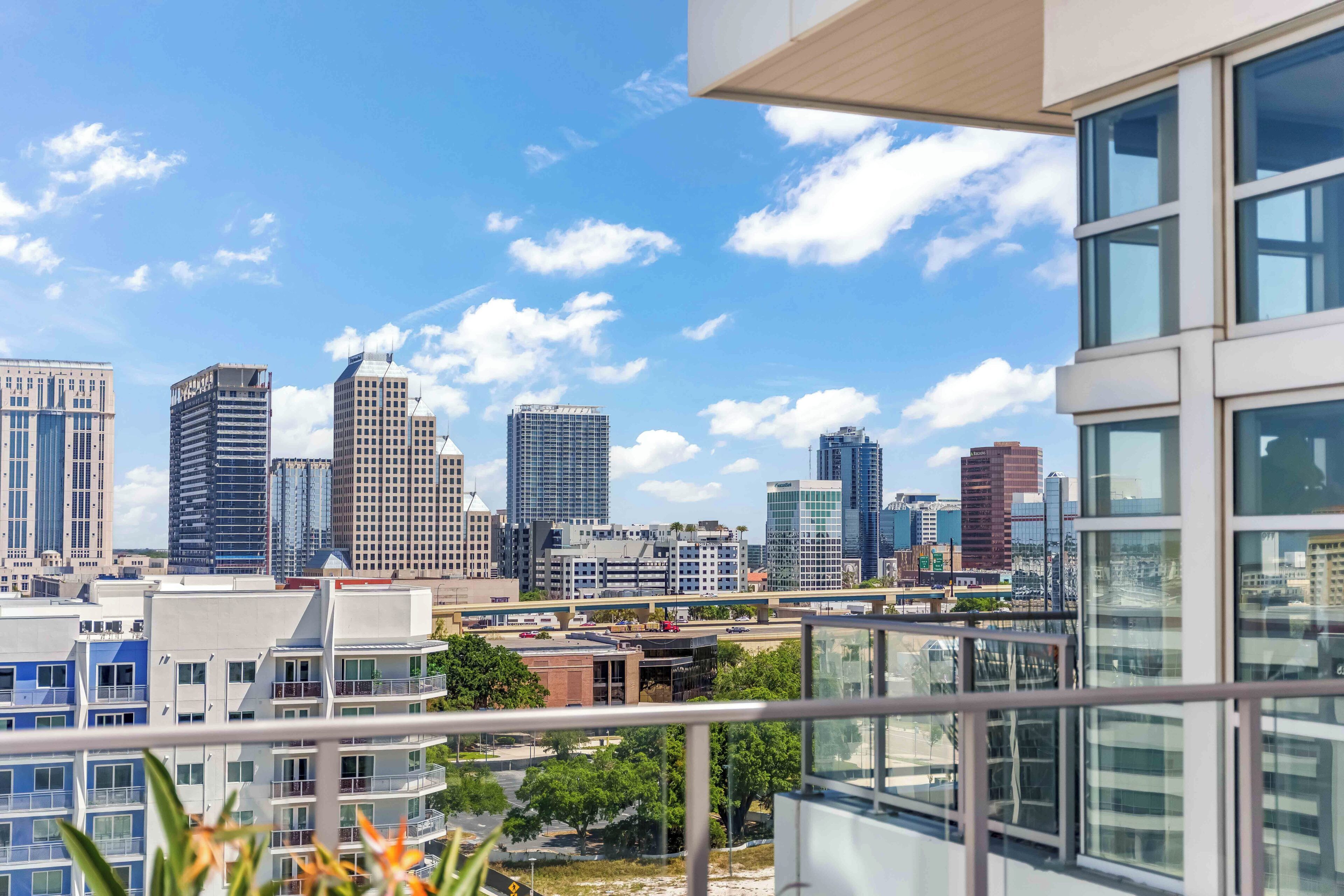 A cityscape with modern buildings and a clear sky.