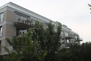 A modern multi-story building with balconies, large windows, and a flat roof. - Holiday apartment with 2 bedrooms (Cuxhaven)