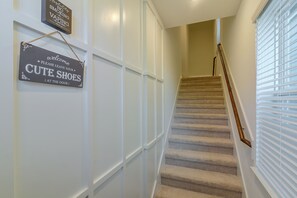 A staircase with a sign that says 'Welcome Please Leave Your CUTE SHOES (At the Door)'.