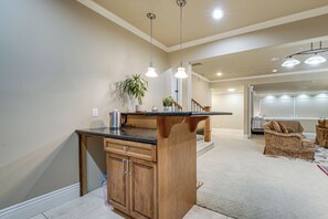 A kitchen with wooden cabinets, a countertop, and pendant lighting. - Full Kitchen & Laundry! Kirkland Studio Suite (Kirkland)