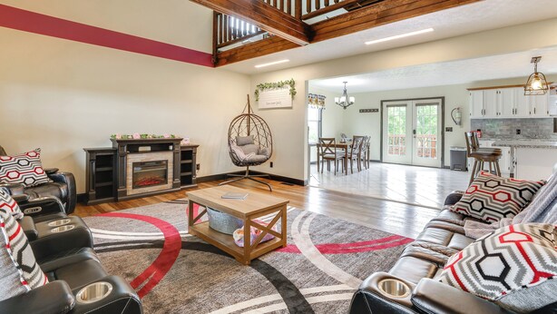 A spacious living room with a fireplace, seating area, and a view of the dining area. - Game Room & Countryside Views! Salvisa Family Gem (Salvisa)