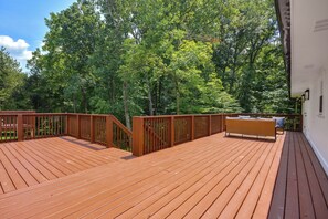 A wooden deck with a railing, surrounded by trees. - Office, Deck, Yard: Thomasville Gem on Golf Course (Thomasville)