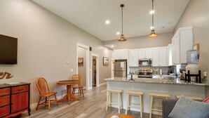 A modern kitchen with white cabinets, a built-in microwave, and a stainless steel refrigerator. - Near Parks & Dtwn Clarinda! 'house of Stroburg' (Clarinda)