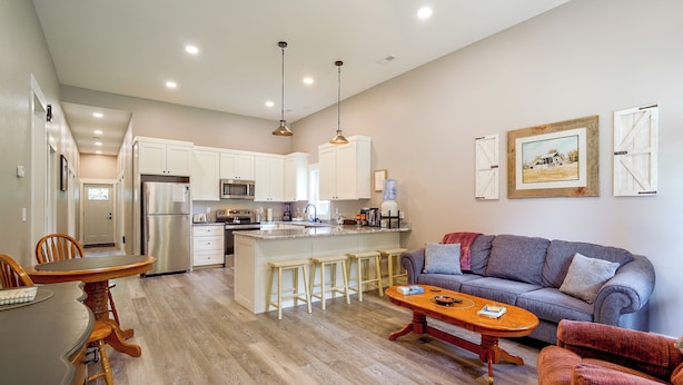 A modern kitchen with white cabinets, stainless steel appliances, and a central island with bar stools. - Near Parks & Dtwn Clarinda! 'house of Stroburg' (Clarinda)