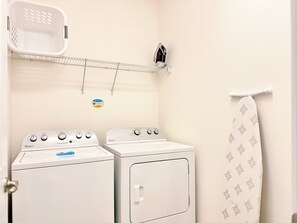 A laundry area with two Whirlpool washers, a hanging rack, and a towel rack. - Sonoma Resort, 6 Suites, Prime Location, Private Pool, Cinema & Games (Kissimmee)