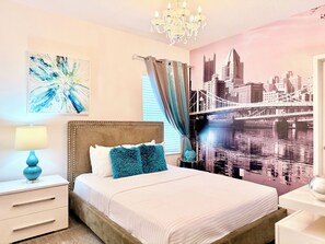 A bedroom with a bed, a nightstand, a lamp, a wall mural, and a chandelier. - Sonoma Resort, 6 Suites, Prime Location, Private Pool, Cinema & Games (Kissimmee)