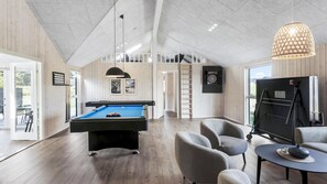 A modern indoor space with a pool table, comfortable seating, and a large window. - VillaVilla 1001 - Marielyst, Lolland/Falster/møn (Idestrup)