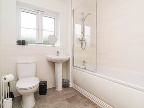 A bathroom with a toilet, sink, and shower. - Higher Gorse (Barnstaple)