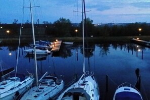 Ein Yachthafen mit mehreren dort festgemachten Booten bei Nacht.