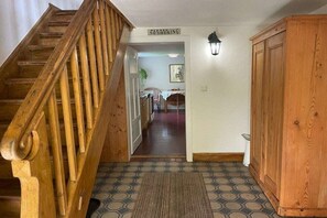 A wooden staircase leading to a room with a 'No Smoking' sign, a patterned rug, and a cabinet. - Holiday home at Krechenbach (Eckarts)