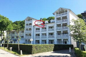 A multi-story hotel with balconies and a central courtyard. - Seaside joy at the Baltic Sea House (Binz)