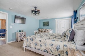 A bedroom with a bed, dresser, and a ceiling fan. - Lincoln City Amazing View Retreat: Hot Tub, Arcade Room, Steps to Beach (Lincoln City)