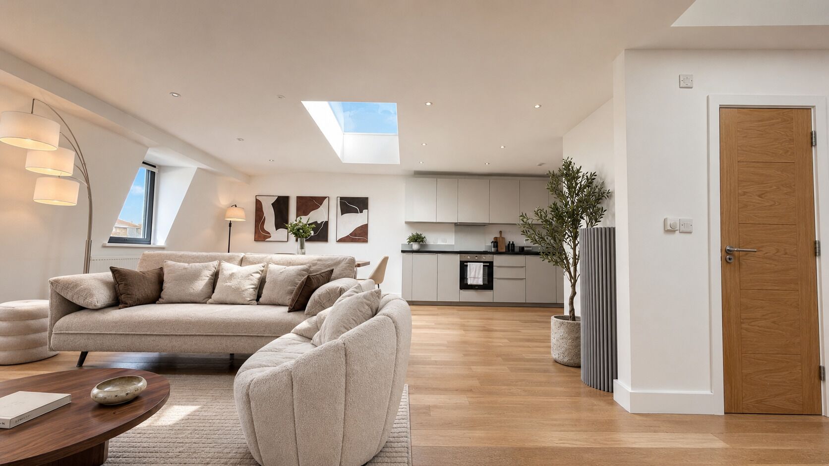 A modern living room with a sofa, a coffee table, and a dining area with a table and chairs.